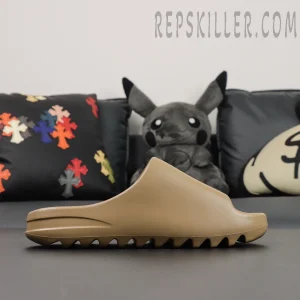 Yeezy Slides ‘Ochre’ side profile on couch background showing clean silhouette