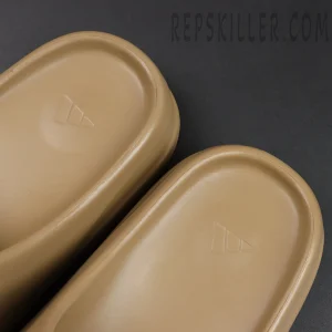 Footbed close-up of Yeezy Slides ‘Ochre’ showing Adidas three-stripe logo