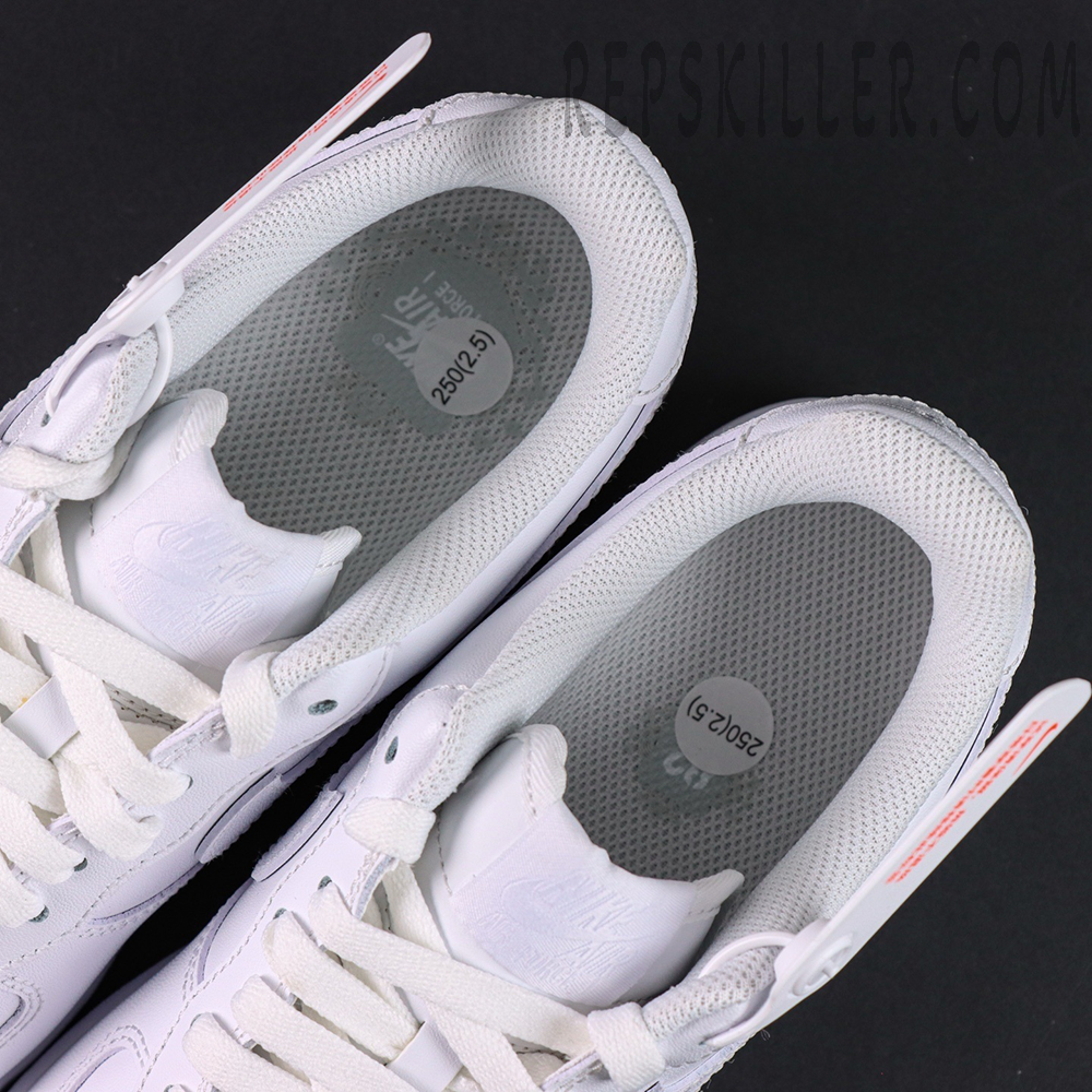 Overhead view of Nike Air Force 1 ’07 “Triple White” showing grey mesh insoles with size stickers.