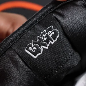 Close-up of embroidered BXGS logo tag inside Bronx Girls Skate x Nike Dunk Low SB ‘Mel & Kava’