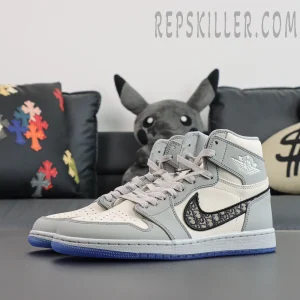 Frontal angled pair shot of Dior x Air Jordan 1 High sneakers on a dark surface.