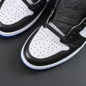 Close-up of perforated white leather toe box with black overlays on Fragment Design x Air Jordan 1 Retro High OG
