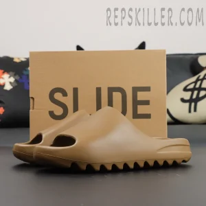 Outsole display of the adidas Yeezy Slides ‘Soot’ emphasizing the traction grooves.