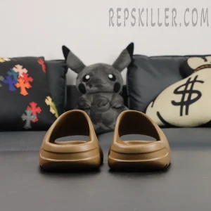 Heel-side diagonal view of the adidas Yeezy Slides ‘Soot’ revealing layered back design.