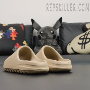 Yeezy Slides ‘Pure’ 2021 Re-Release rear heel angle on couch background