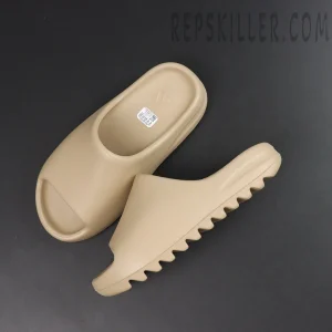 Flat lay of Yeezy Slides ‘Pure’ 2021 Re-Release showcasing both slides