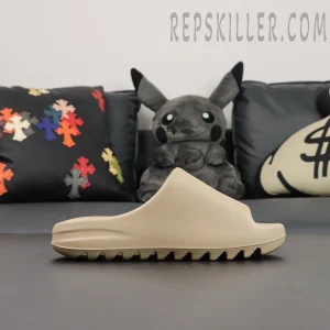Side profile of Yeezy Slides ‘Pure’ 2021 Re-Release on sofa setup