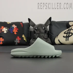 Side profile of Yeezy Slides ‘Salt’ highlighting the wave-textured outsole.