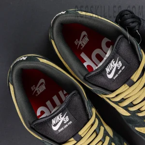 Nike Supreme x Dunk Low SB “Camper Green” insole view highlighting red Supreme logo print and black SB tongue label.
