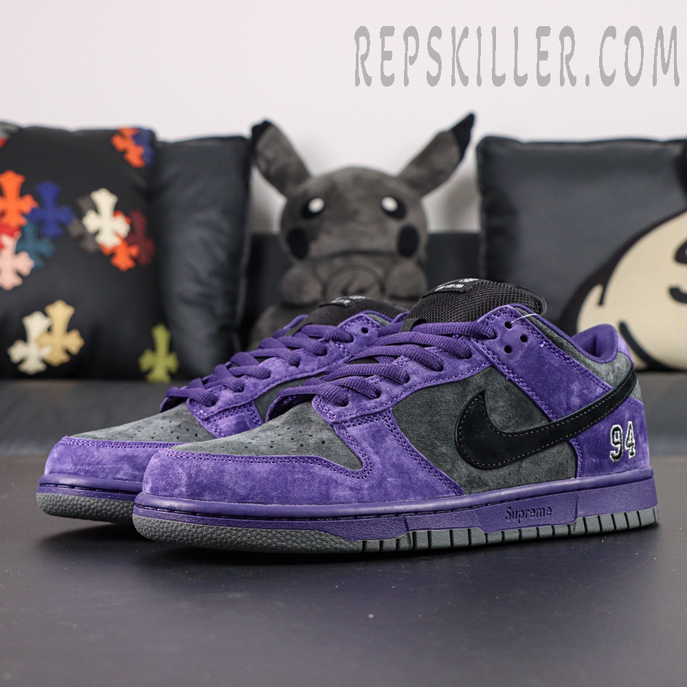 Nike Supreme x Dunk Low SB “Ink” side view showcasing purple and charcoal suede upper with black Swoosh and “94” embroidery.