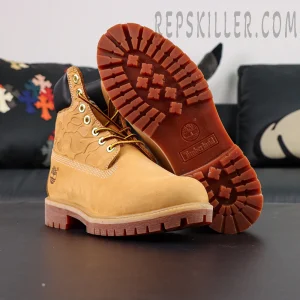 Sole view of A Bathing Ape x Undefeated x Timberland 6 Inch “Wheat” showing red-brown traction outsole with Timberland logo.