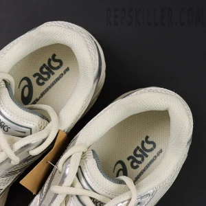 Top view of ASICS GEL-Kayano 14 “Birch Dark Pewter” with visible asics logo on insoles.