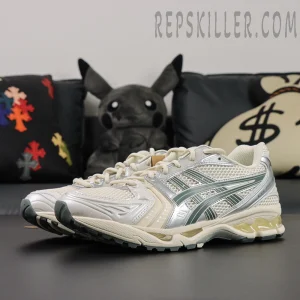 Angled view of ASICS GEL-Kayano 14 “Birch Dark Pewter” pair highlighting reflective accents and GEL midsole.