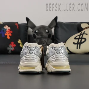 Back view of ASICS GEL-Kayano 14 “Birch Dark Pewter” pair with visible GEL technology.