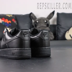 Rear angled view of Nike Air Force 1 ’07 “Triple Black” showing embossed Nike Air heel logos.