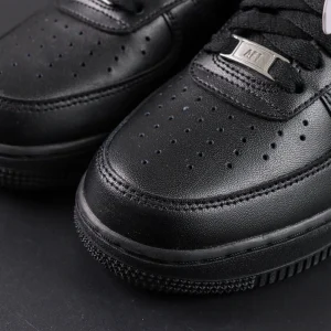 Close-up of Nike Air Force 1 ’07 “Triple Black” toe box highlighting perforations and leather texture.