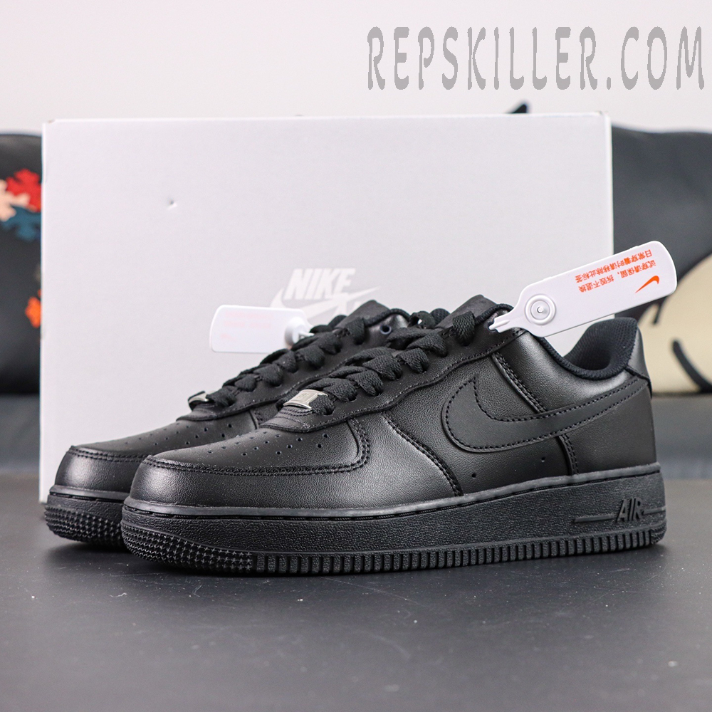 Pair of Nike Air Force 1 ’07 “Triple Black” with grey box background showing minimalist design.
