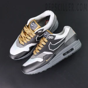 Top-down view of Nike Air Max 1 “Low Poly - Big Head Mode” showing layered upper design and gold lace contrast.