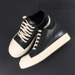 Top-down view of Hollywood Low “Black Milk” showing black and cream contrast design and flat laces.