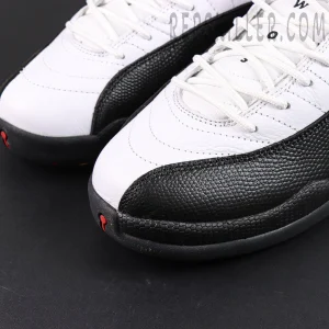 Close-up of Air Jordan 12 Retro “Taxi” 2025 toe box showing white leather upper and black textured mudguard.