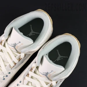 Top view of Air Jordan 3 “Ivory” showing fuzzy lining and metallic Jumpman embroidery on tongue.