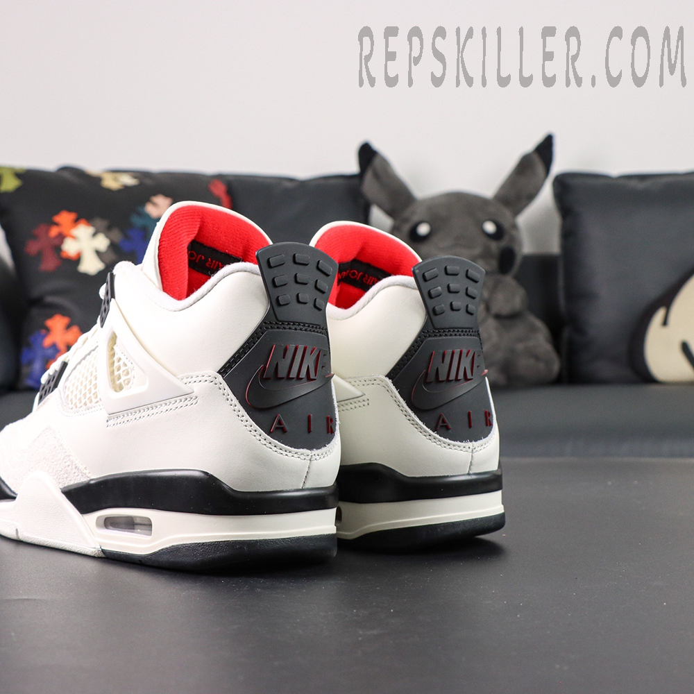Rear angle of Air Jordan 4 Retro “Flight Club” showing black Nike Air heel tab and red inner lining.
