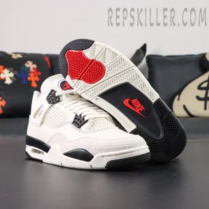 Bottom view of Air Jordan 4 Retro “Flight Club” featuring red and black outsole with Nike logo.