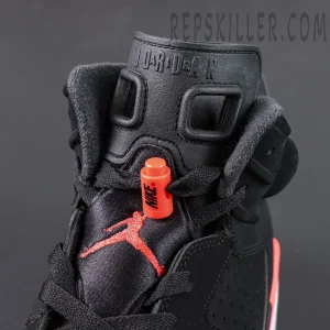 Jordan 6 “Reverse Infrared” Black / Light Crimson tongue area showing embossed “JORDAN” text and red lace lock.