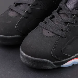 Jordan 6 “Reverse Infrared” Black / Light Crimson close-up on toe section showing fine texture and build quality.