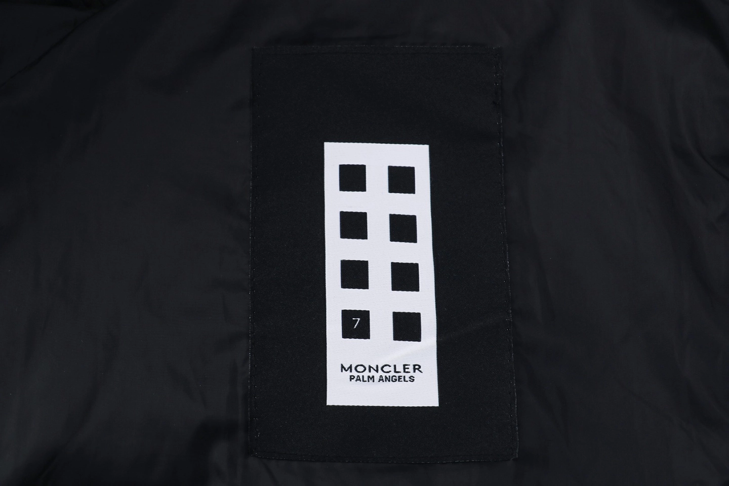 Mxxcler x Pharrell Williams Oversized Logo Puffer Jacket Wash label