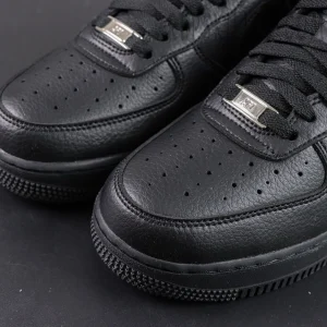 Close-up of NOCTA x Air Force 1 “Certified Lover Boy” toe box showing perforations and leather texture.