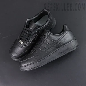 Overhead pair of NOCTA x Nike Air Force 1 Low “Certified Lover Boy” showing premium white tumbled leather and engraved midsole text.