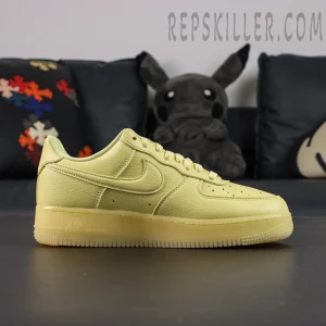 Side profile of NOCTA x Air Force 1 “Citron Tint” highlighting monochrome yellow tumbled leather construction.
