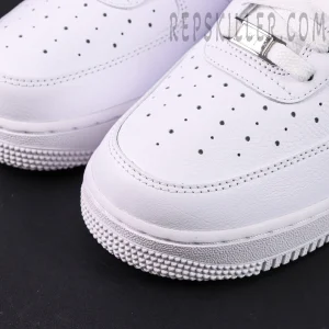 Close-up of NOCTA x Air Force 1 “Certified Lover Boy” toe box showing perforations and leather texture.