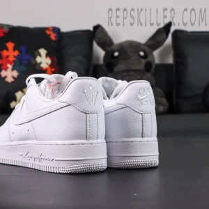 Angled rear view of NOCTA x Nike Air Force 1 “Certified Lover Boy” showing white leather construction and dual heel logos.