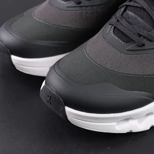 Toe area close-up of ON L × Cloudtilt 2 “Black” showing layered texture and rubberized tip.