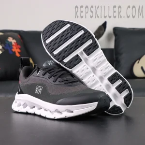 Outsole view of ON L × Cloudtilt 2 “Black” showing black rubber traction and white cushioning design.
