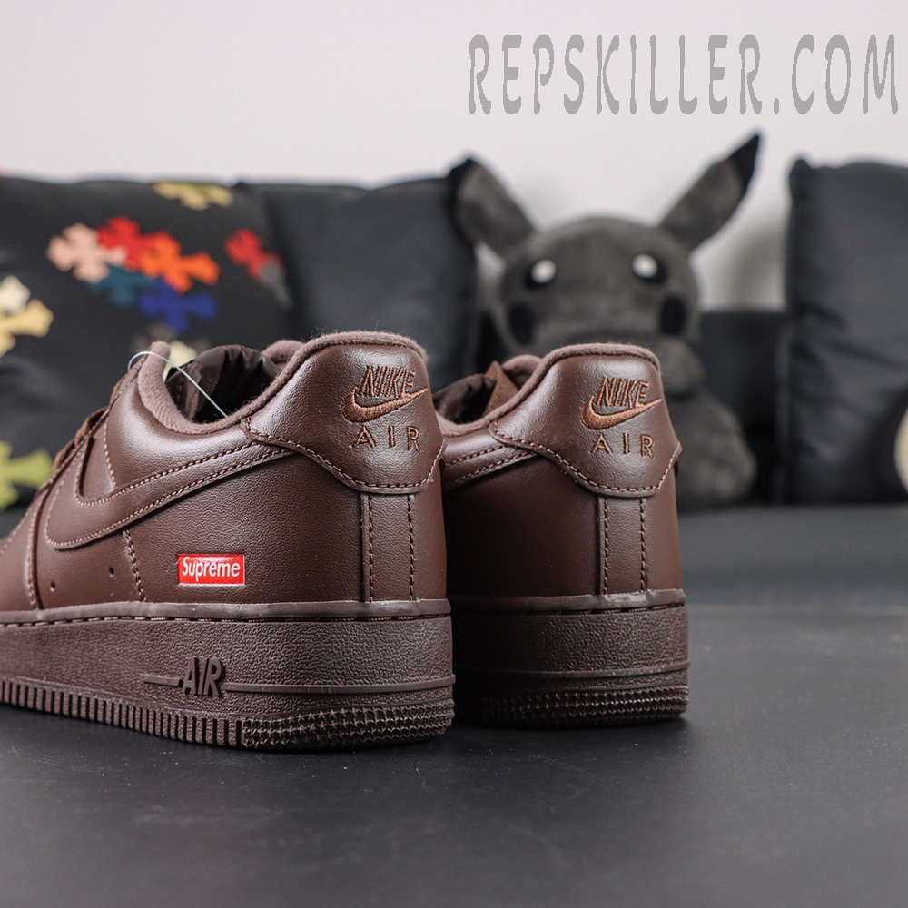 Rear heel view of Sup x Air Force 1 Low SP ‘Box Logo - Baroque Brown’ featuring embossed Nike Air logo and red Supreme patch
