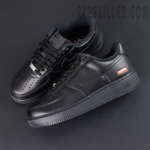 Overhead view of Sup x Air Force 1 Low SP ‘Box Logo - Black’ showcasing premium black leather upper and red Supreme tag