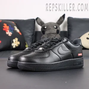 Angled front view of Sup x Air Force 1 Low SP ‘Box Logo - Black’ showing tonal swoosh and perforated toe box