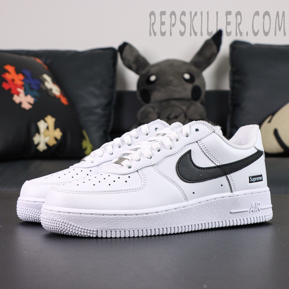 Side angle of Supreme x Nike Air Force 1 Low SP ‘Box Logo - White Black’ featuring black swoosh and white leather upper