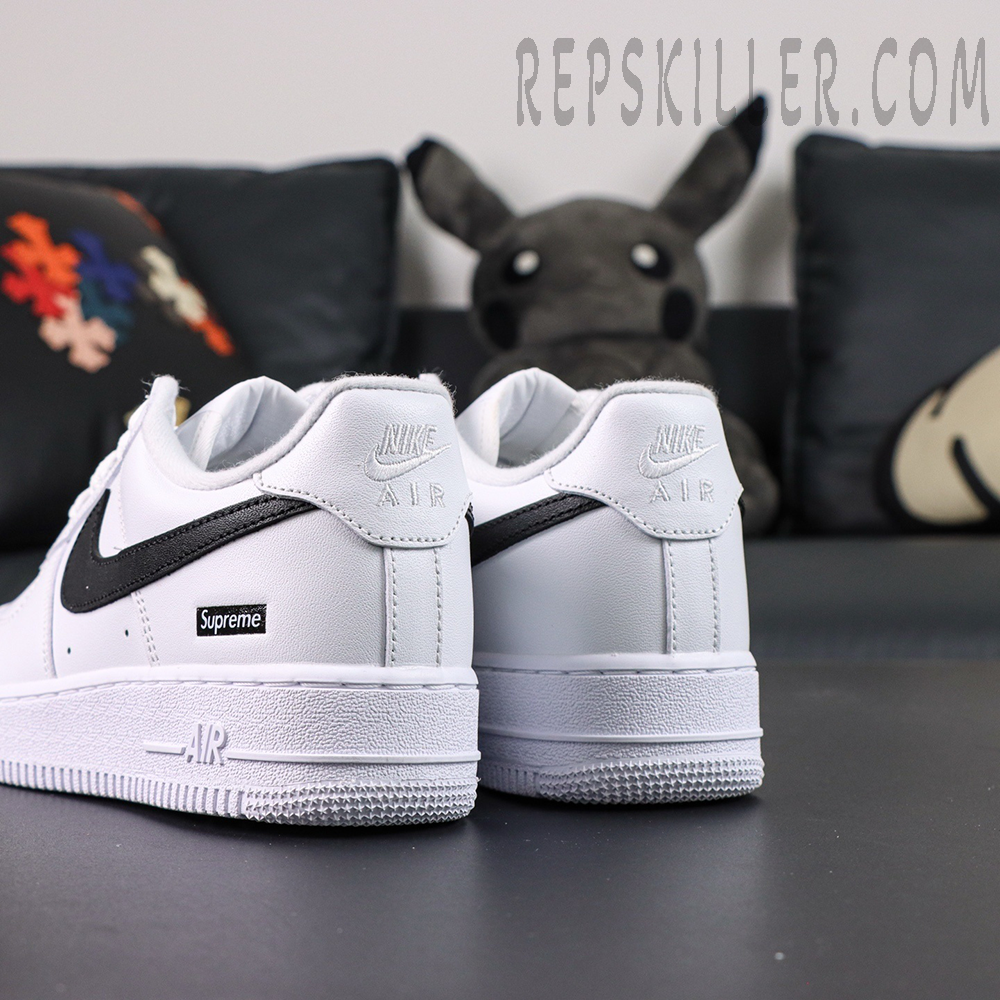 Rear heel view of Supreme x Nike Air Force 1 Low SP ‘Box Logo - White Black’ showing embossed Nike Air and black swoosh detail