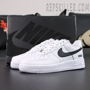 Supreme x Nike Air Force 1 Low SP ‘Box Logo - White Black’ with Nike shoebox in background and bold black swoosh