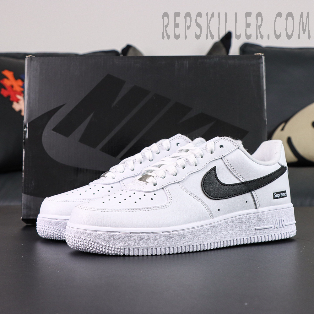 Supreme x Nike Air Force 1 Low SP ‘Box Logo - White Black’ with Nike shoebox in background and bold black swoosh