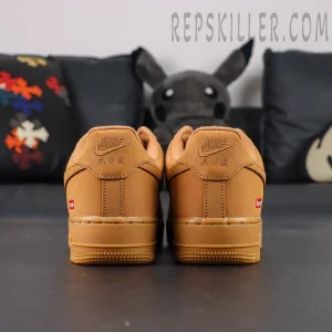 Back heel view of Sup x Air Force 1 Low SP ‘Box Logo - Wheat’ emphasizing embossed Nike Air and red Supreme tag
