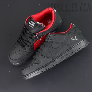 Nike Supreme x Dunk Low SB “Black” top angle view showing 94 embroidery, black swoosh, and red interior.