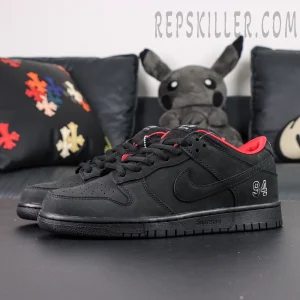 Nike Supreme x Dunk Low SB “Black” full pair display emphasizing red interior contrast and detailed construction.