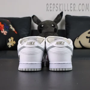 Nike Supreme x Dunk Low SB “White Metallic Silver” rear view showing embroidered Nike heel logo and clean white leather finish.