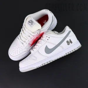 Nike Supreme x Dunk Low SB “White Metallic Silver” top view showing perforated toe box and red insole details.