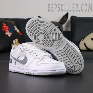 Nike Supreme x Dunk Low SB “White Metallic Silver” outsole display showing classic circular traction pattern.